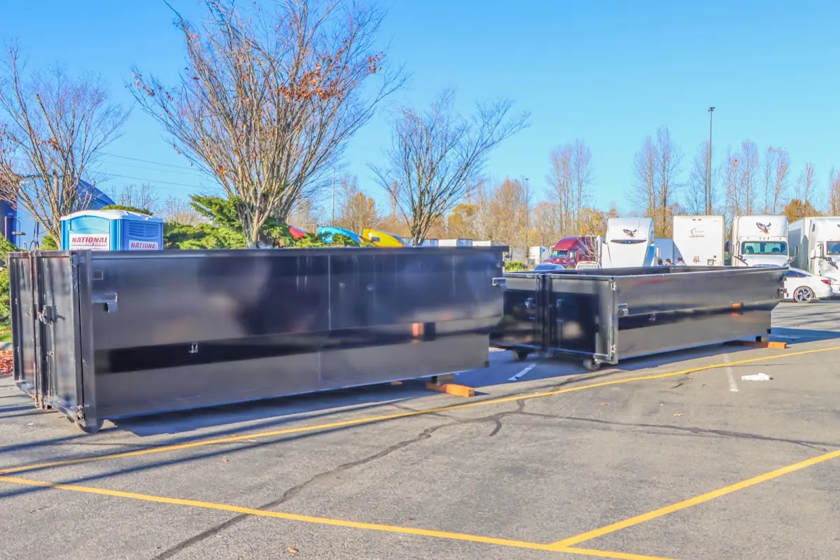 Professional dumpster rental service with roll-off container on residential driveway in Biloxi